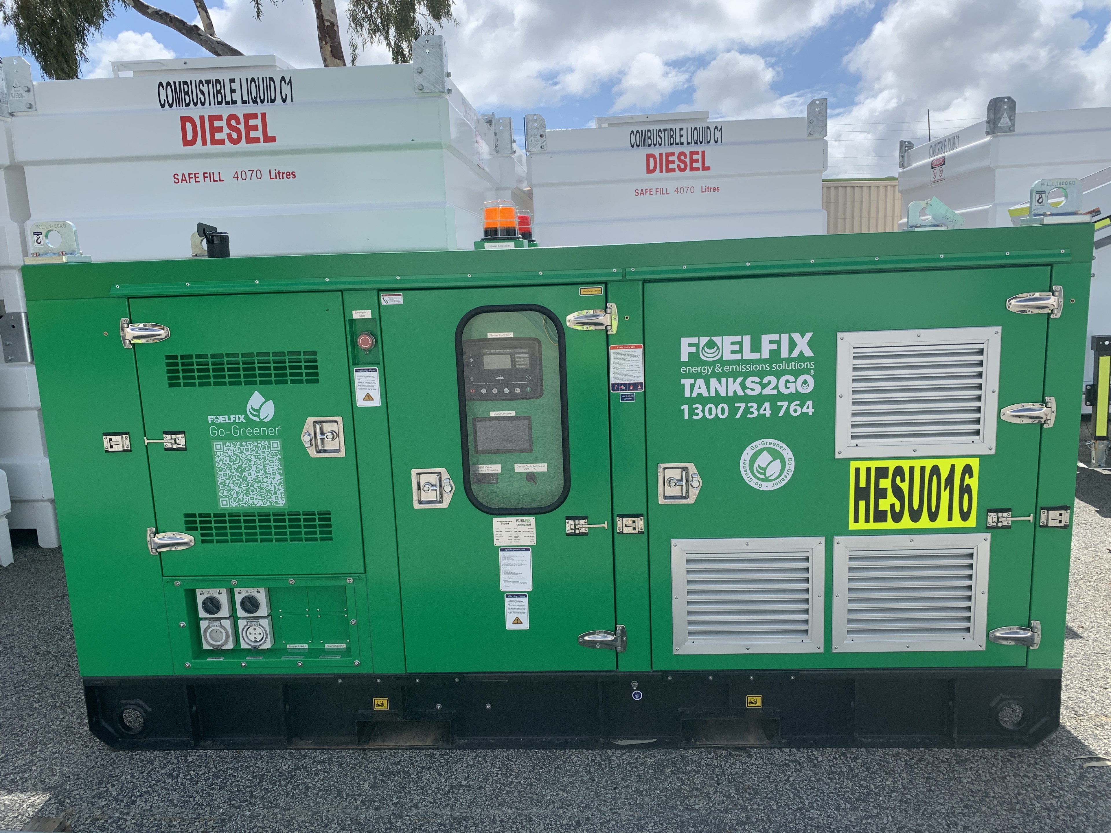 Hybrid Generator HESU20 displayed in the yard near small fuel pods